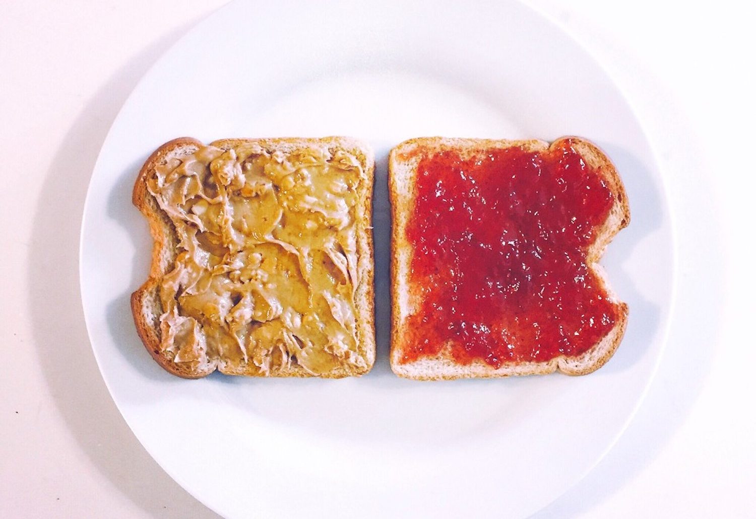 An Image of two bread toasts with different flavours in a plate.